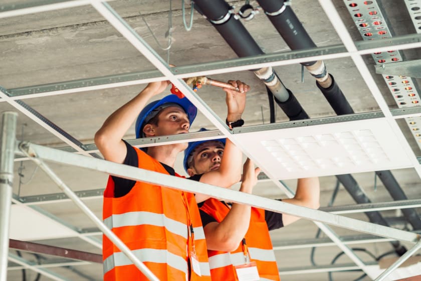 technicians doing preventative building maintenance on an interior ceiling